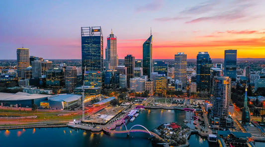 Vibrant city skyline at sunset with colorful lights reflecting on the water symbolizing inner energy, mental clarity, and vitality during the winter season.