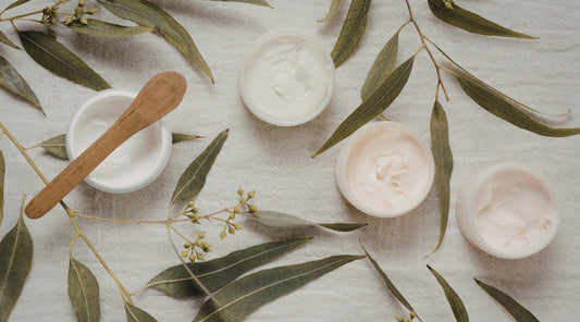 Natural wellness products arranged with eucalyptus leaves, representing a simple and realistic wellness routine.