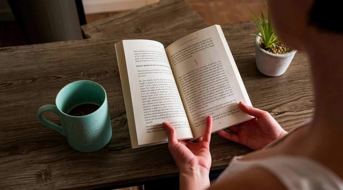 Reading a book with coffee as part of simple spring wellness habits for rest, energy and everyday wellbeing